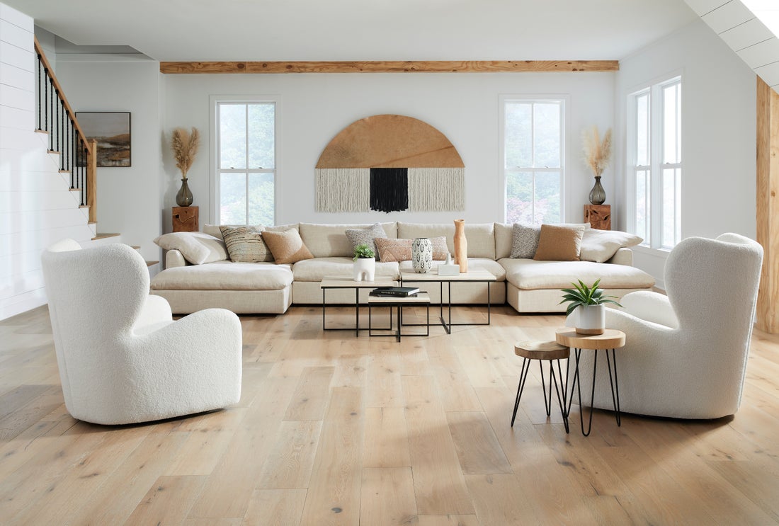 Layered indoor living room with collected furniture, textiles, and warm natural light